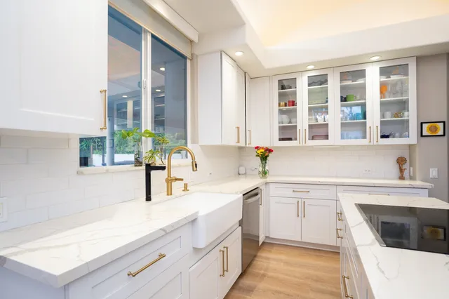 a kitchen with a sink stove and cabinets