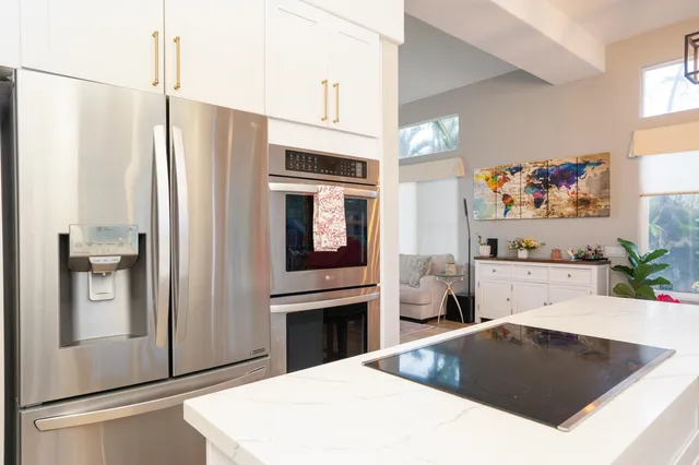 a kitchen with stainless steel appliances a refrigerator and a stove