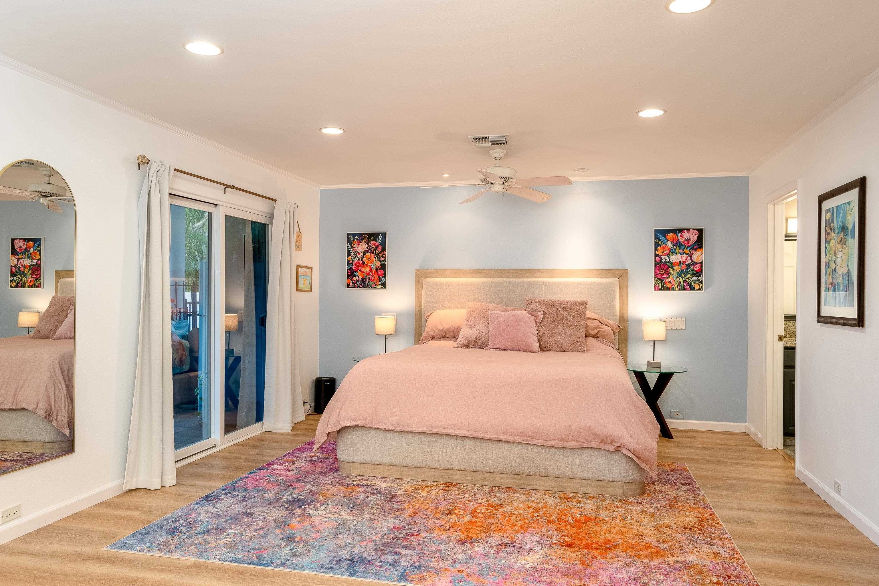 52 Kuukama Street Kahului, HI 96732 - Photo 13 of 28 a bedroom with a large bed and a chandelier