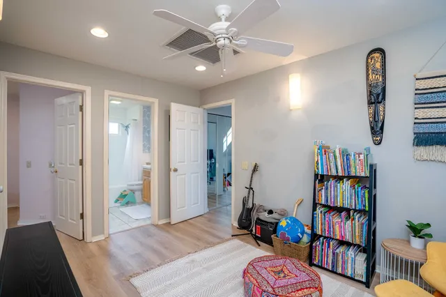 a living room with a book shelf and a book shelf