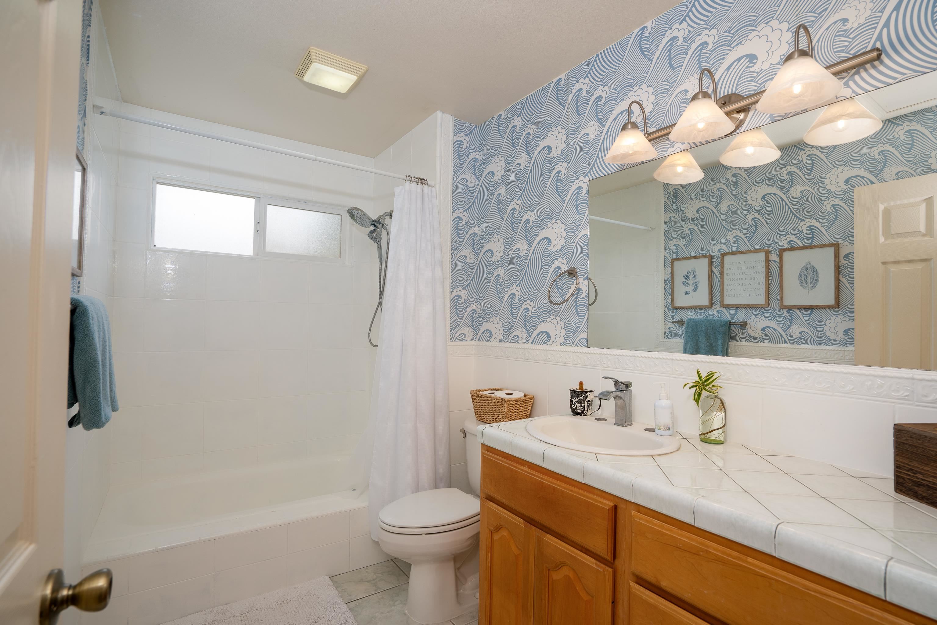 52 Kuukama Street Kahului, HI 96732 - Photo 23 of 28 a bathroom with a sink a toilet and a mirror