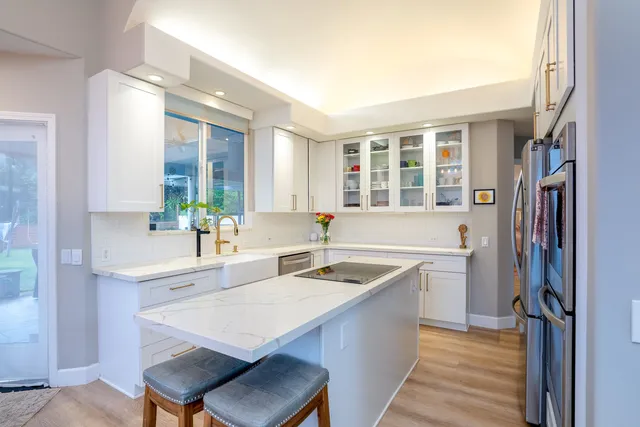 a kitchen with a sink stove and refrigerator
