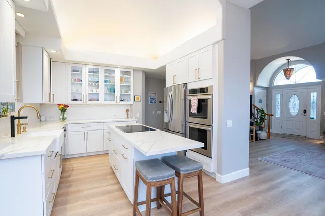 a large kitchen with a table and chairs