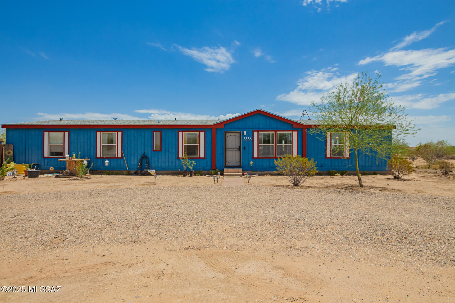 5386 North Whitetail Road Marana, AZ 85653 - Photo 2 of 33 a front view of a house with a yard and garage