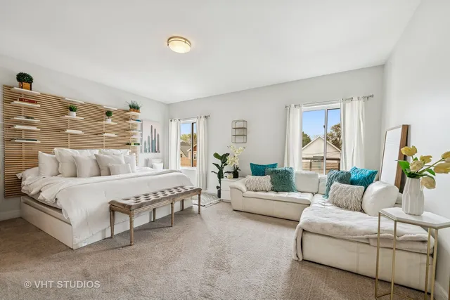 a spacious bedroom with a bed and a couch