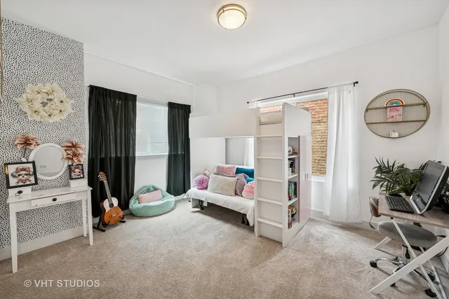 a bedroom with furniture and a chandelier