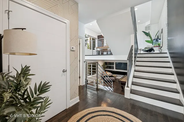 a view of a livingroom with furniture and staircase