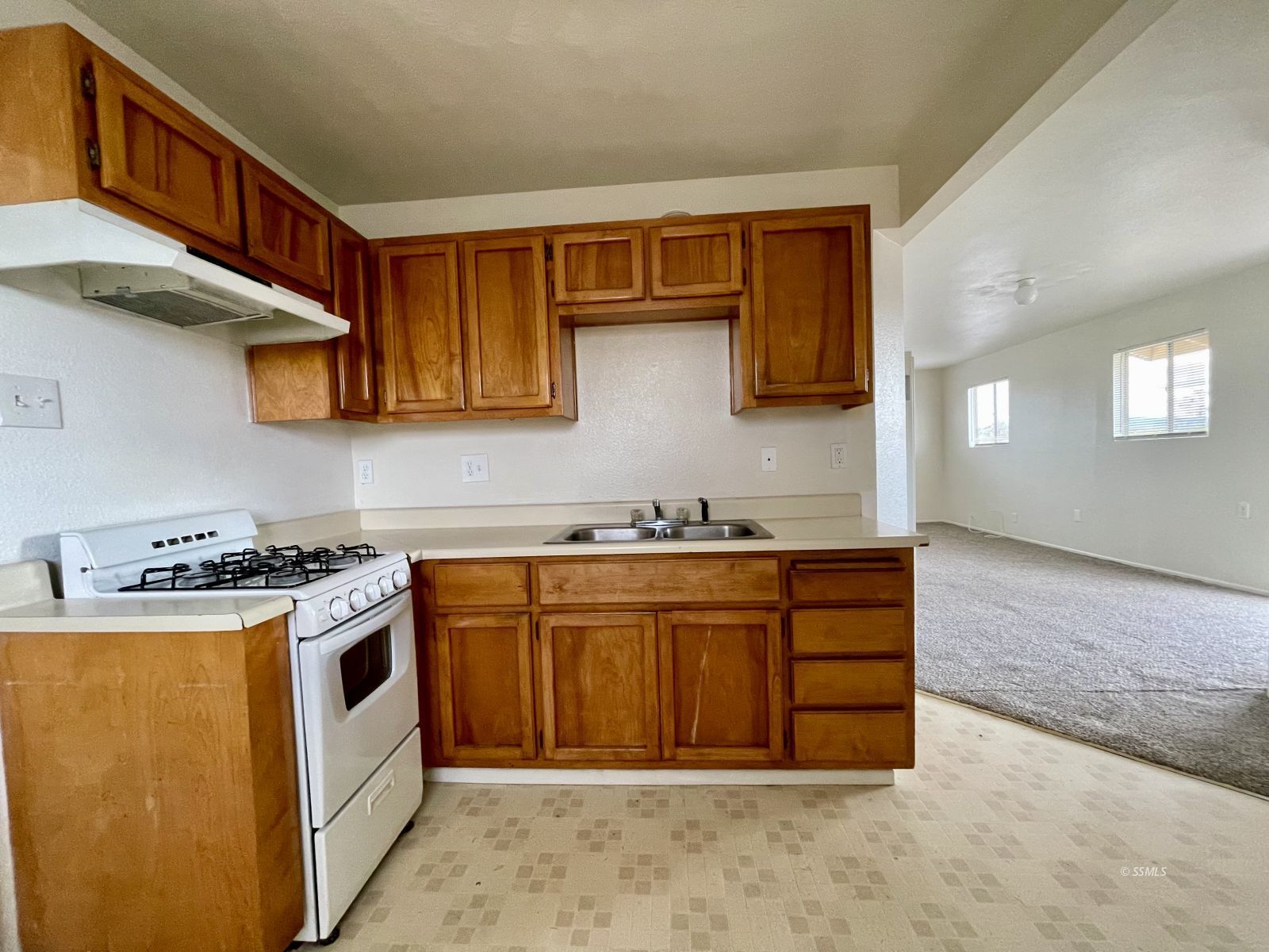 328 North Mono Street Ridgecrest, CA 93555 - Photo 9 of 14 a kitchen with stainless steel appliances granite countertop a stove and a sink