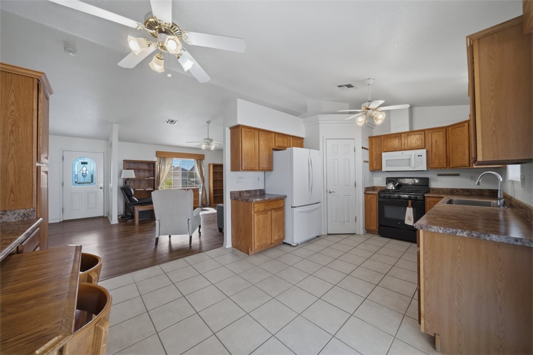 2144 Ridgeview Road Kingman, AZ 86401 - Photo 16 of 49 a kitchen with granite countertop a refrigerator oven a sink dishwasher and cabinets with wooden floor