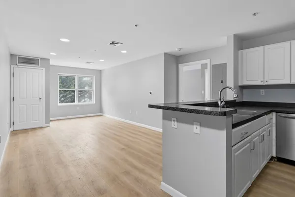 a kitchen with stainless steel appliances granite countertop a sink stove and cabinets