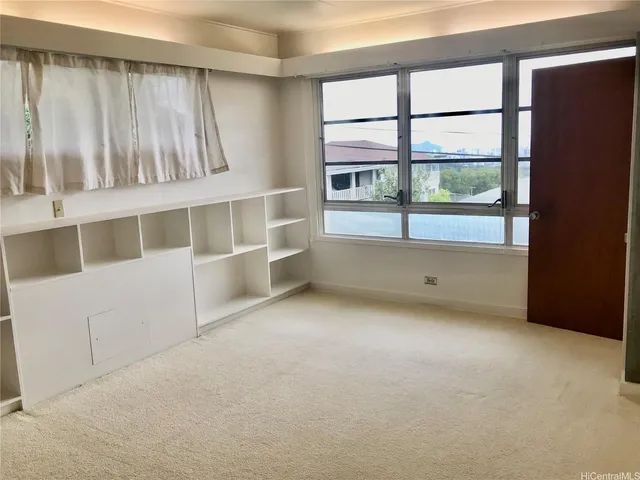 an empty room with furniture and a fireplace