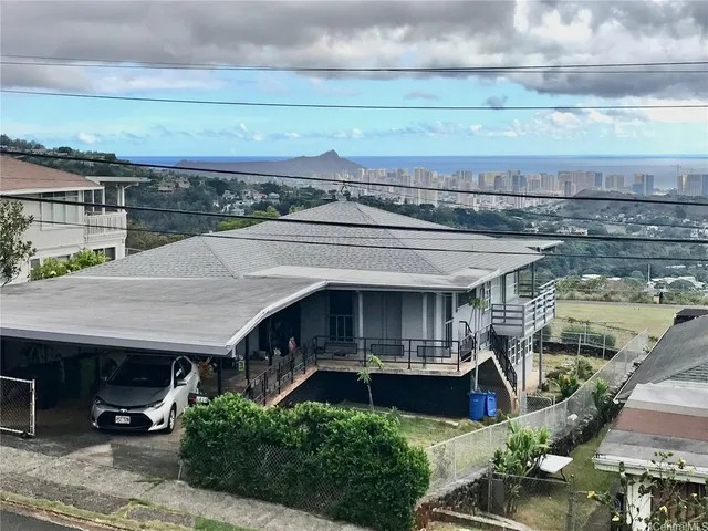 a view of house with outdoor space and sitting area