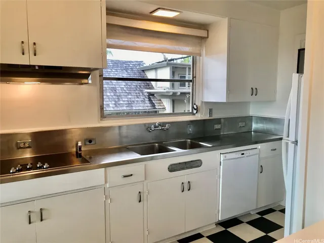 a kitchen with appliances cabinets and a window