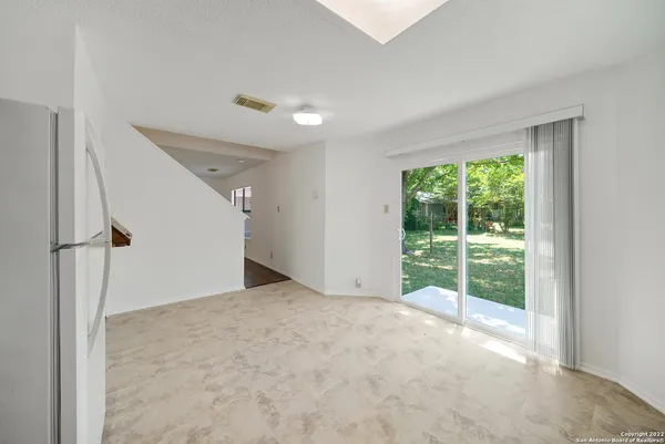 a view of an empty room with windows