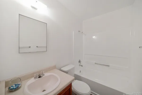 a bathroom with a sink toilet and vanity
