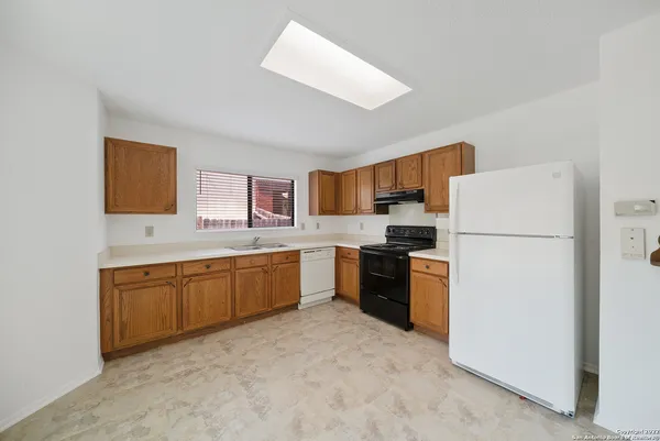 a kitchen with a refrigerator stove and sink