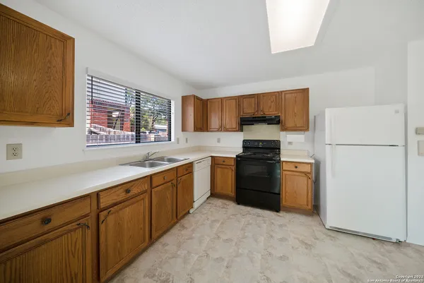 a kitchen with a refrigerator stove and sink