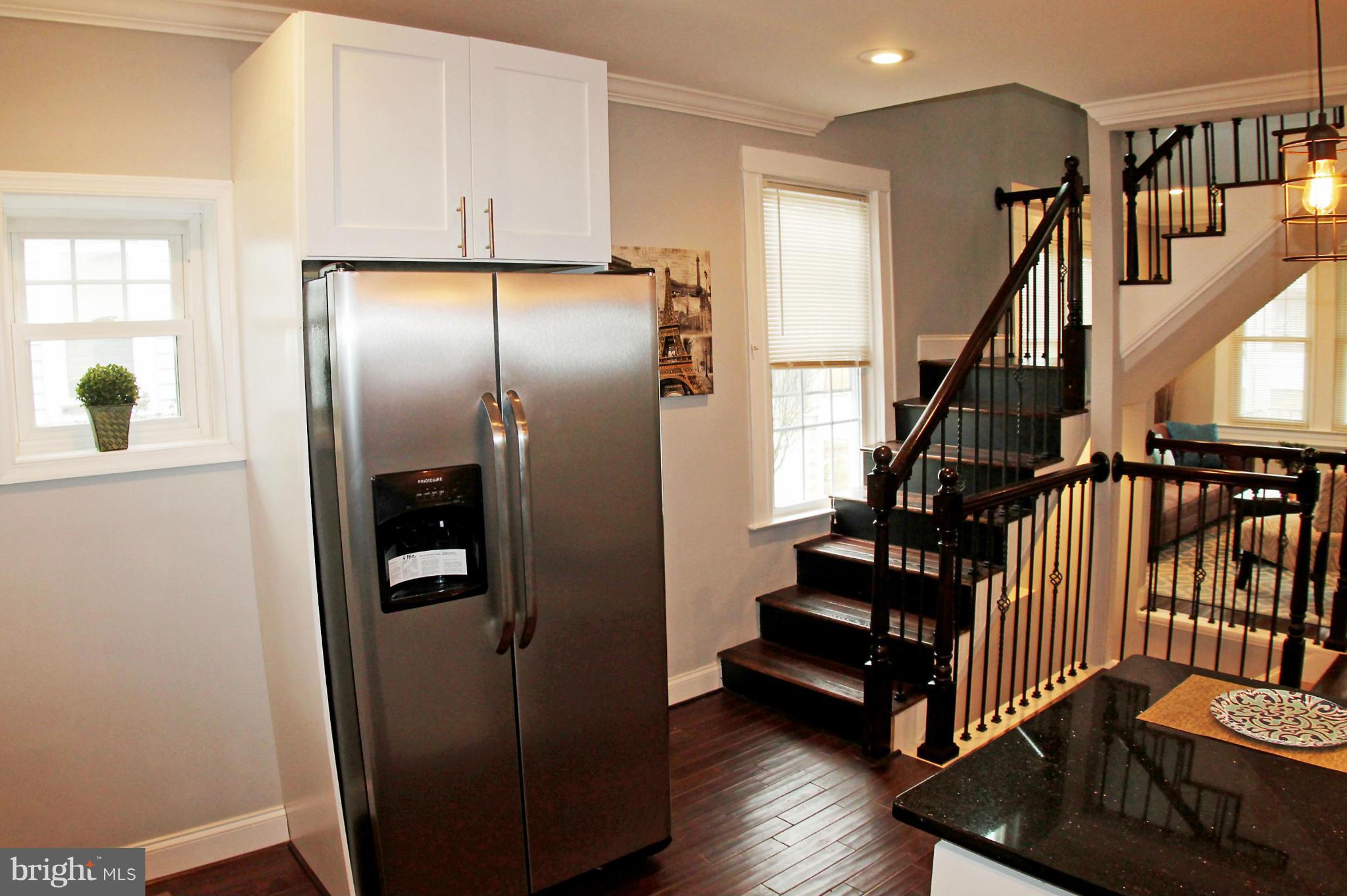 5510 Tramore Road Baltimore, MD 21214 - Photo 13 of 30 a view of entryway with wooden floor and stairs