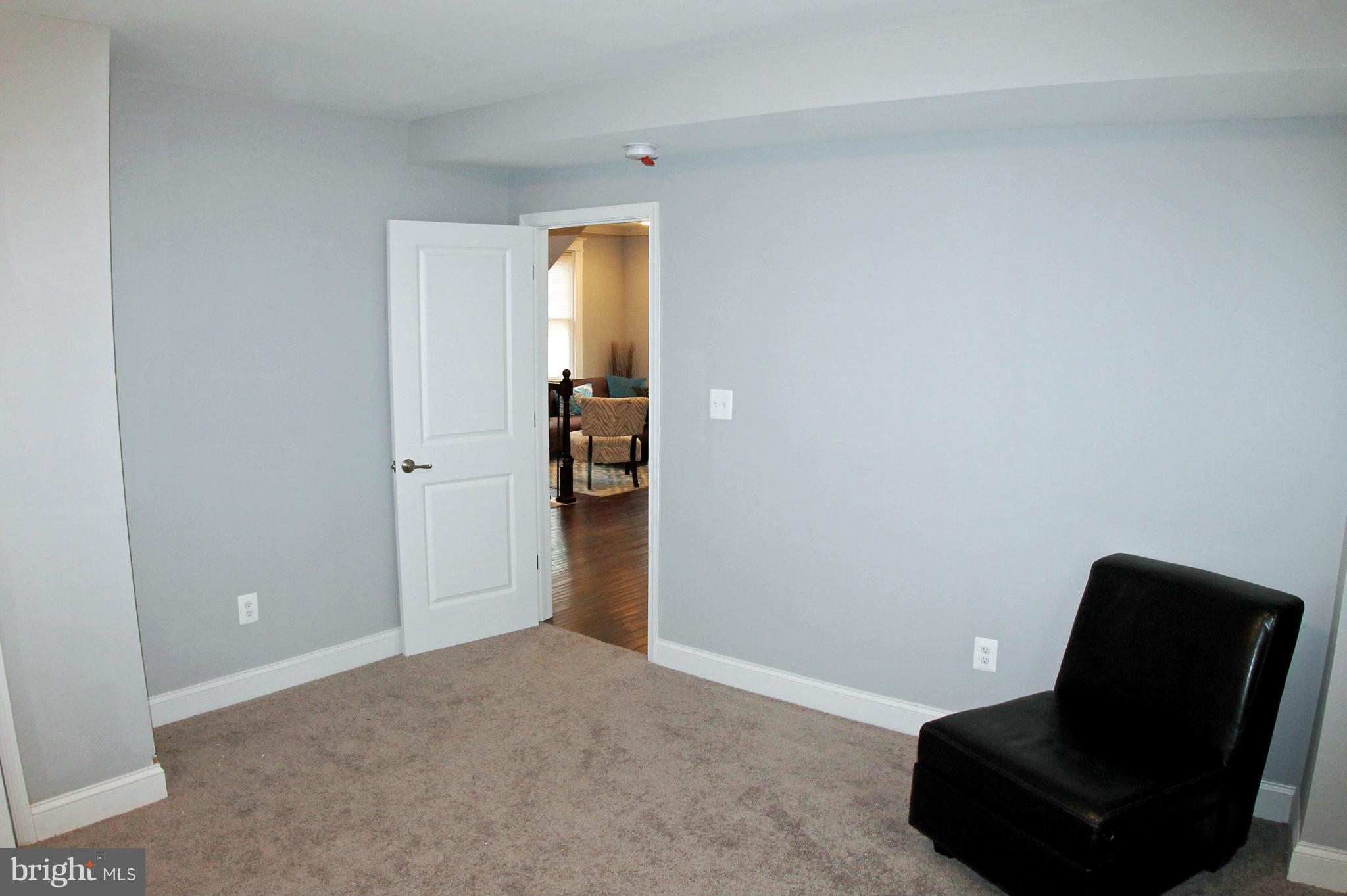 5510 Tramore Road Baltimore, MD 21214 - Photo 17 of 30 a view of room with a chair and potted plant