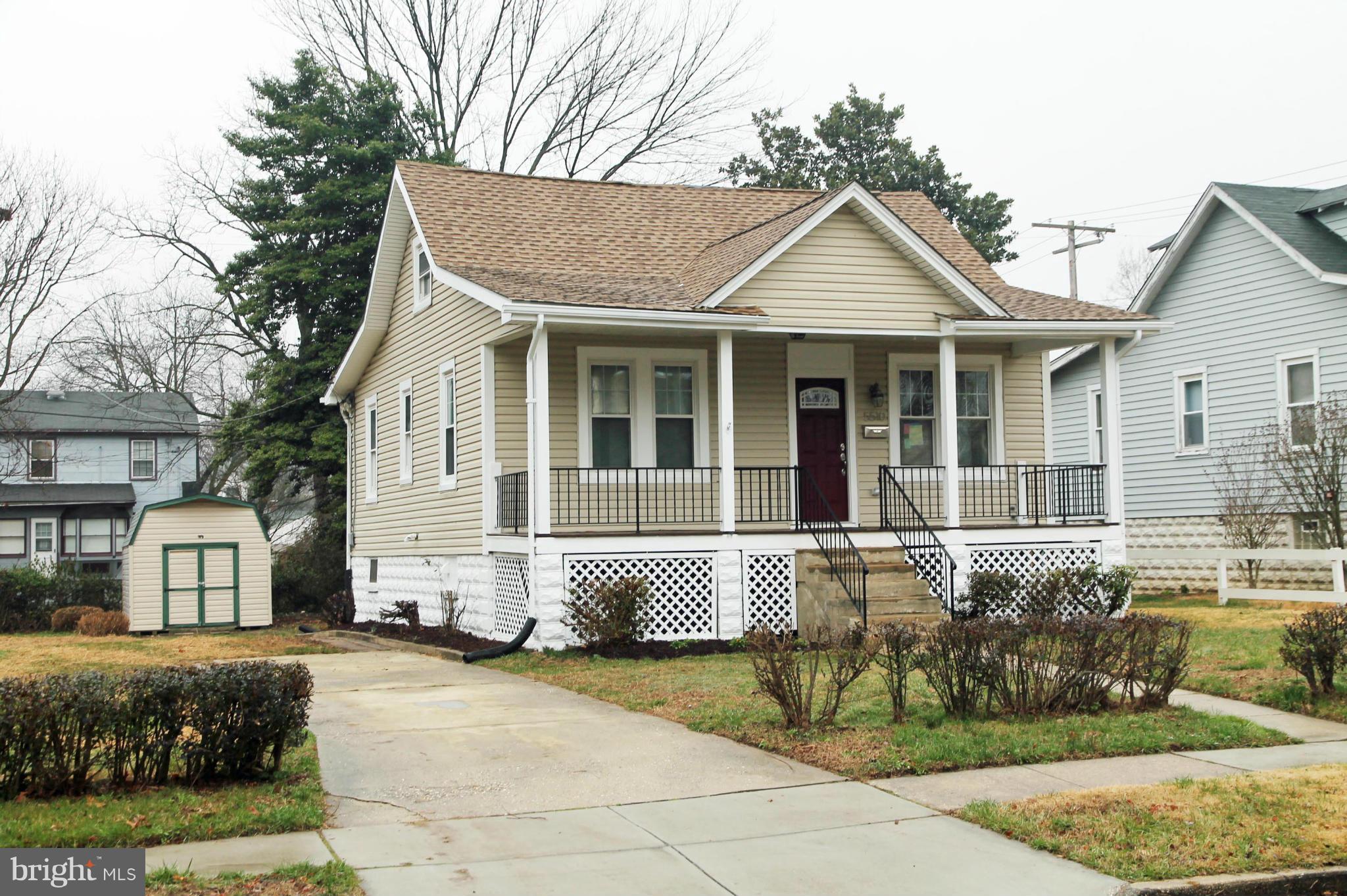 5510 Tramore Road Baltimore, MD 21214 - Photo 3 of 30 a front view of a house with a garden and plants