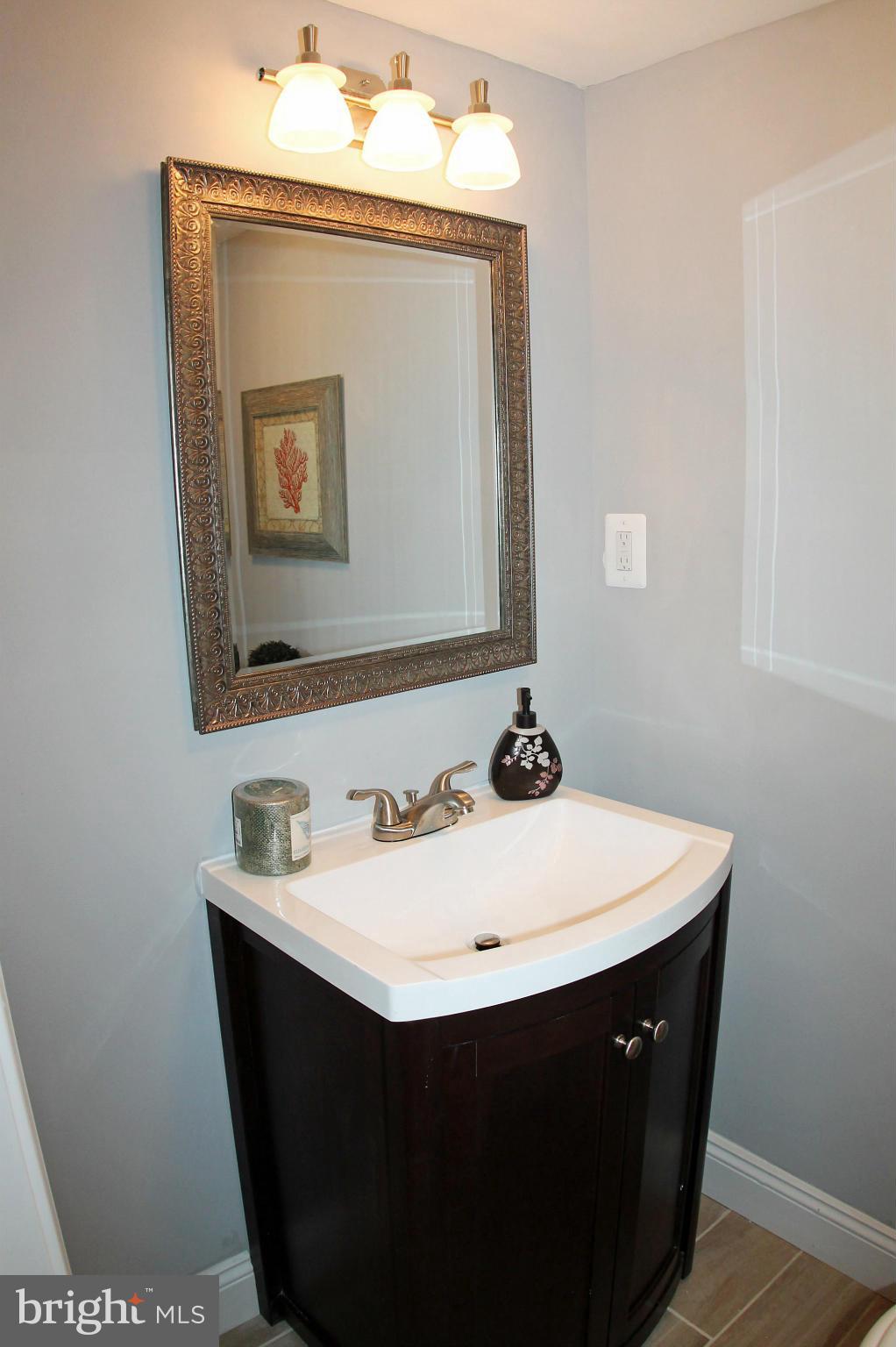 5510 Tramore Road Baltimore, MD 21214 - Photo 26 of 30 a close view of a sink mirror and vanity