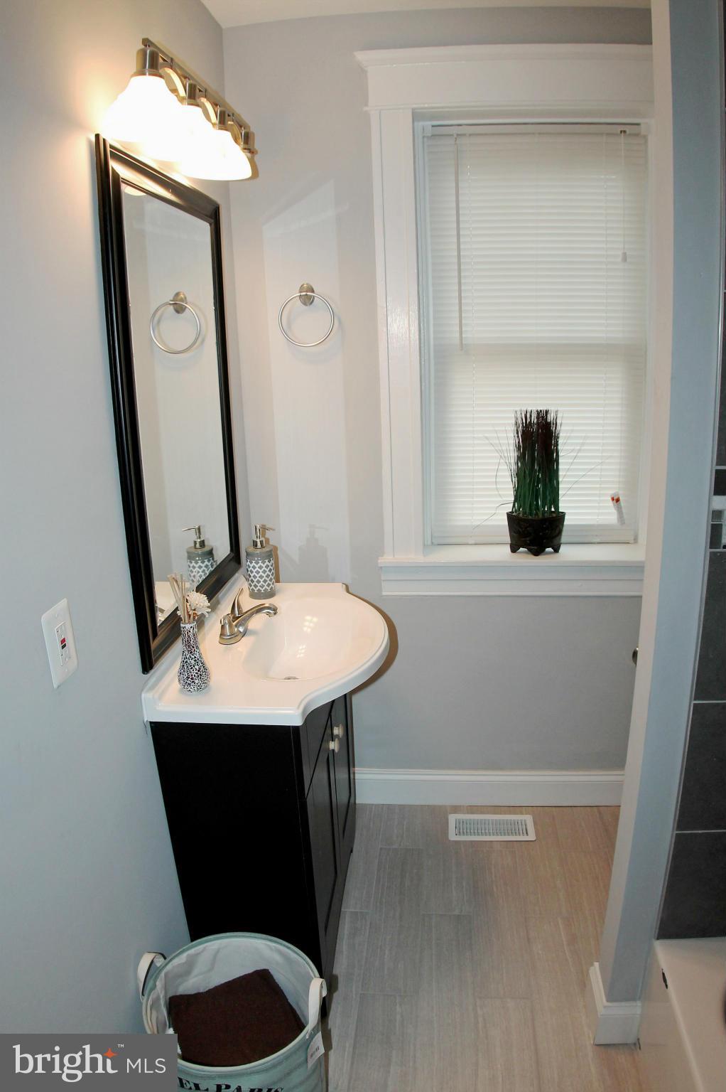 5510 Tramore Road Baltimore, MD 21214 - Photo 27 of 30 a bathroom with a sink a toilet and mirror
