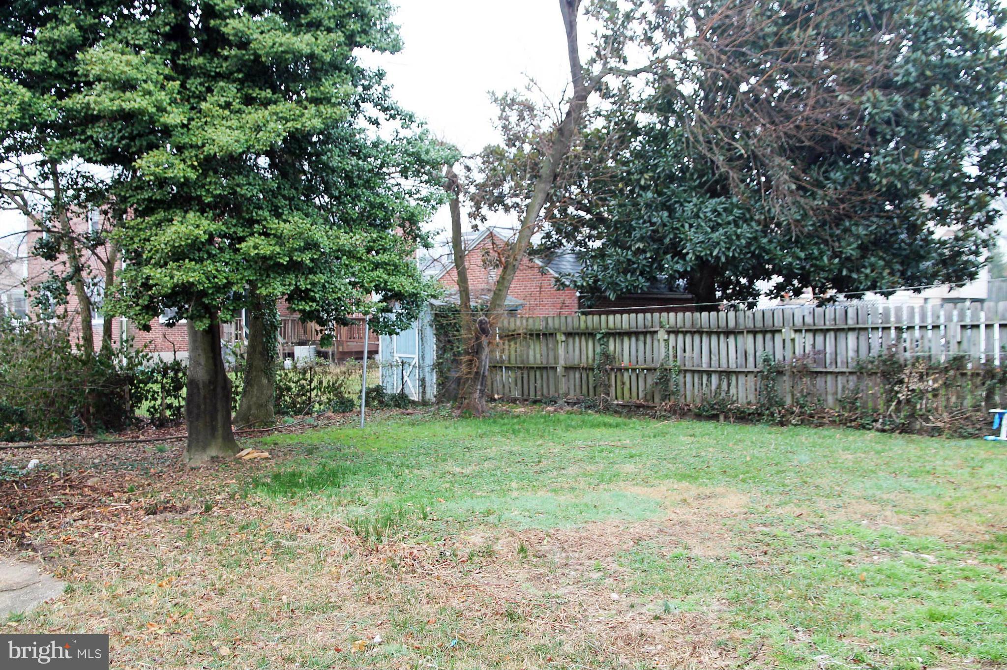 5510 Tramore Road Baltimore, MD 21214 - Photo 30 of 30 a view of a yard with wooden fence and trees