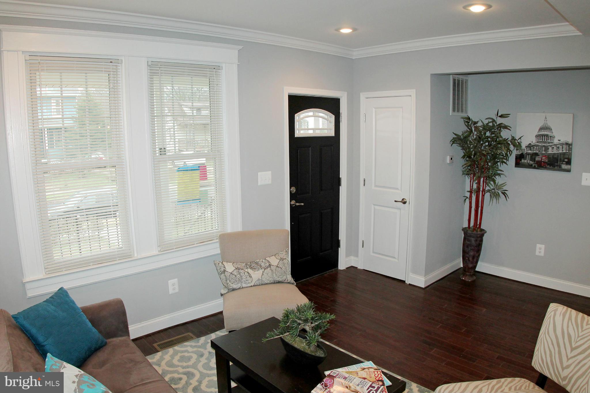 5510 Tramore Road Baltimore, MD 21214 - Photo 8 of 30 a living room with furniture and a potted plant