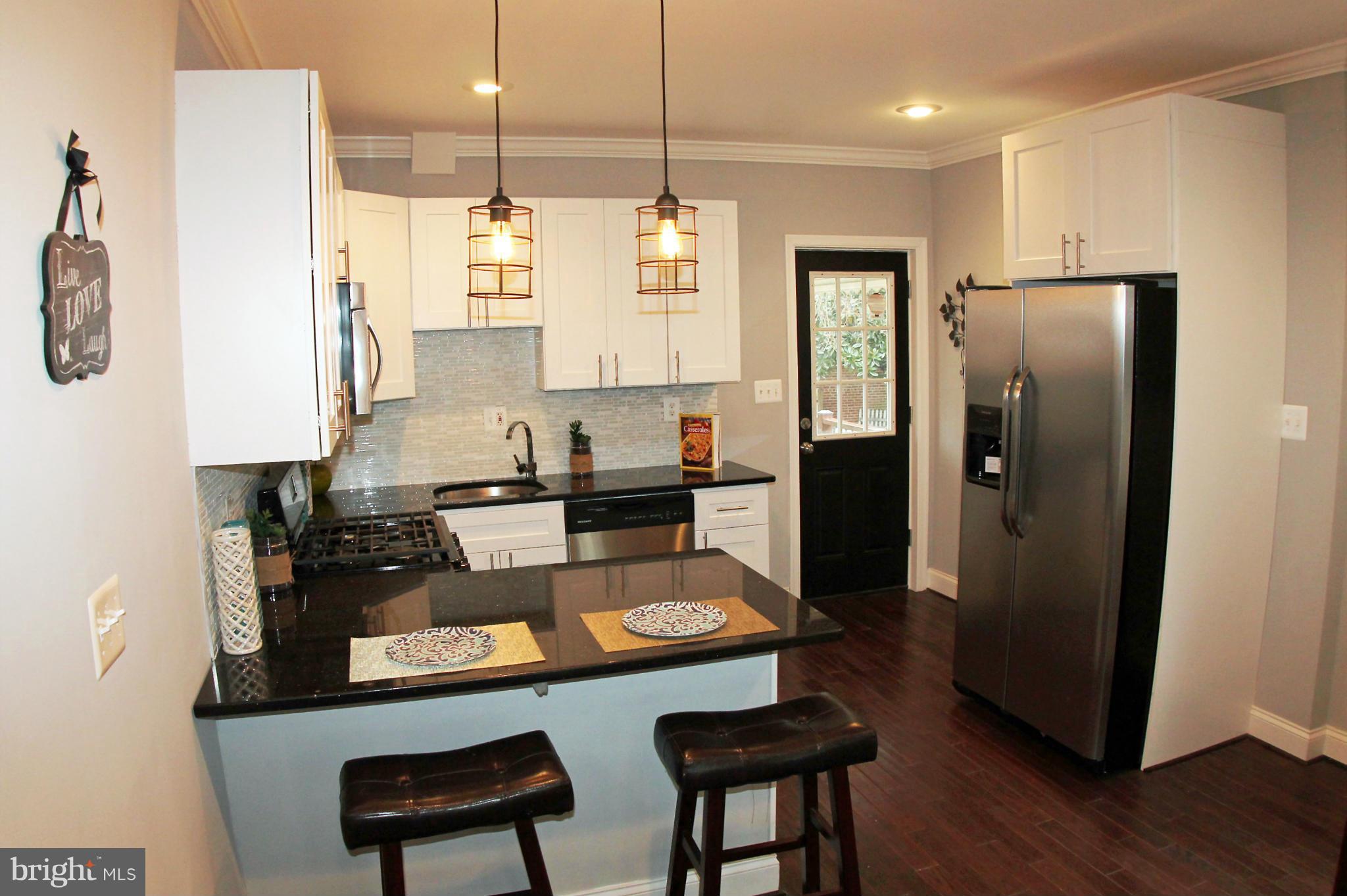 5510 Tramore Road Baltimore, MD 21214 - Photo 9 of 30 a kitchen with refrigerator and window