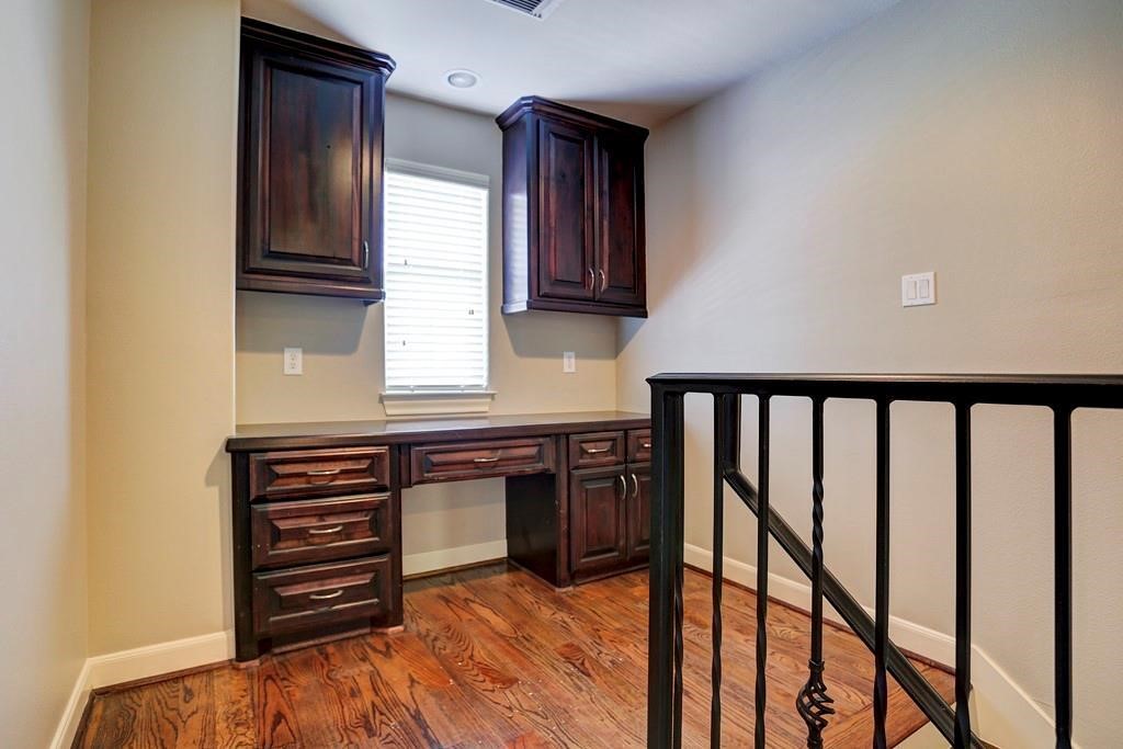923 Birdsall Street Houston, TX 77007 - Photo 9 of 21 a kitchen with wooden cabinets and stove