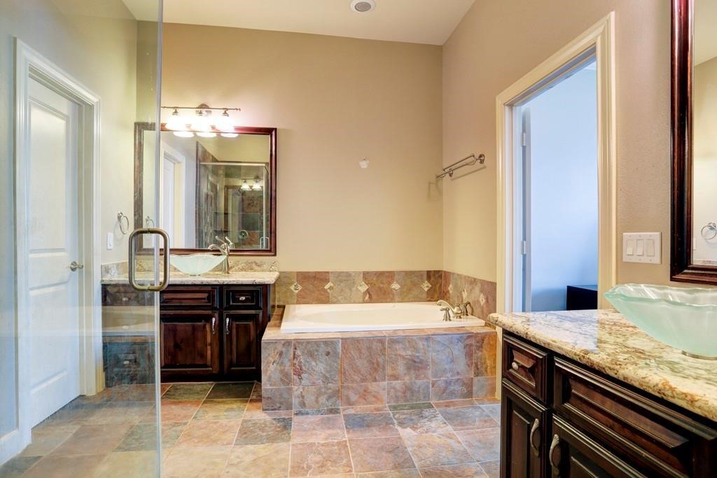 923 Birdsall Street Houston, TX 77007 - Photo 11 of 21 a spacious bathroom with a granite countertop sink and a mirror