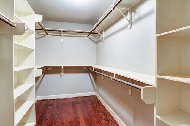 a spacious bathroom with a granite countertop sink and a mirror