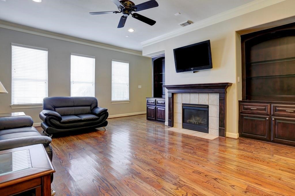 923 Birdsall Street Houston, TX 77007 - Photo 5 of 21 a living room with furniture a flat screen tv and a fireplace