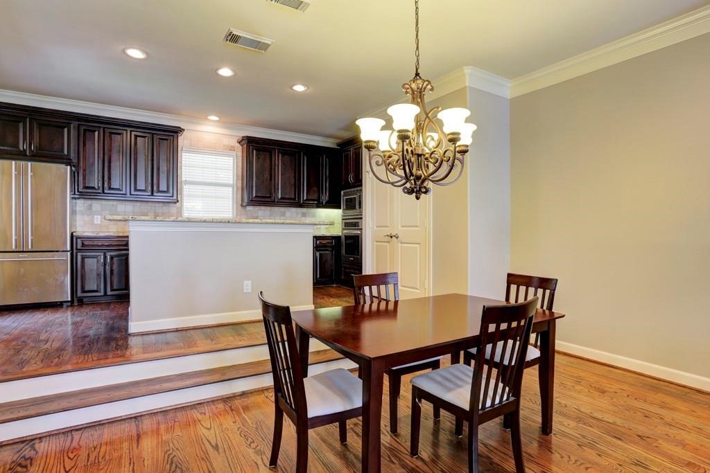 923 Birdsall Street Houston, TX 77007 - Photo 21 of 21 a dining room filled chandelier and wooden floor