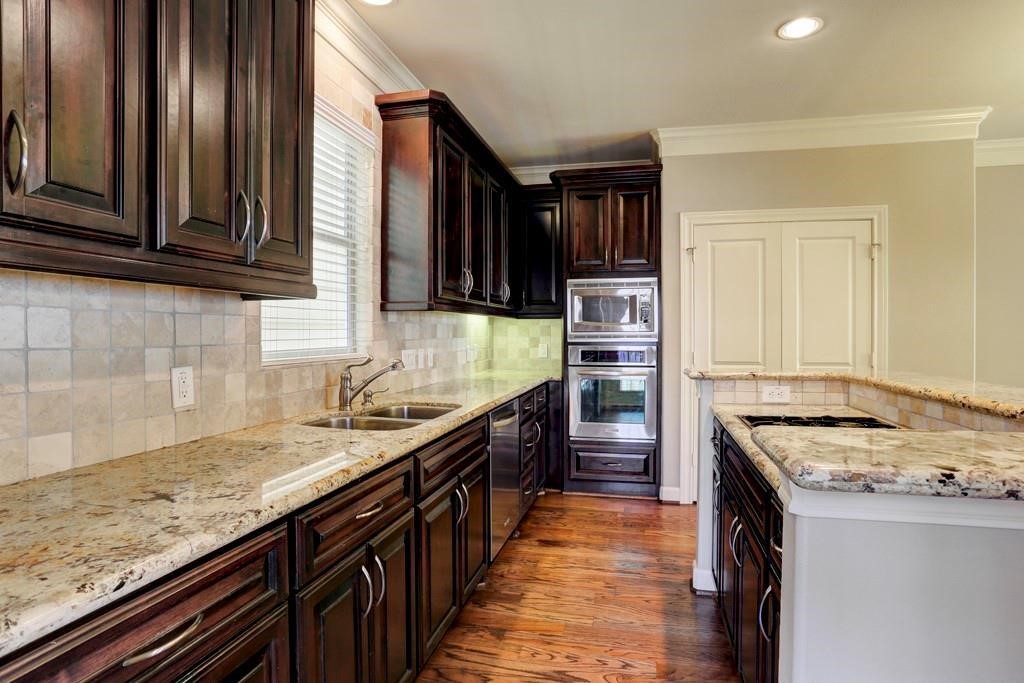 923 Birdsall Street Houston, TX 77007 - Photo 7 of 21 a kitchen with stainless steel appliances granite countertop a stove a sink and a refrigerator