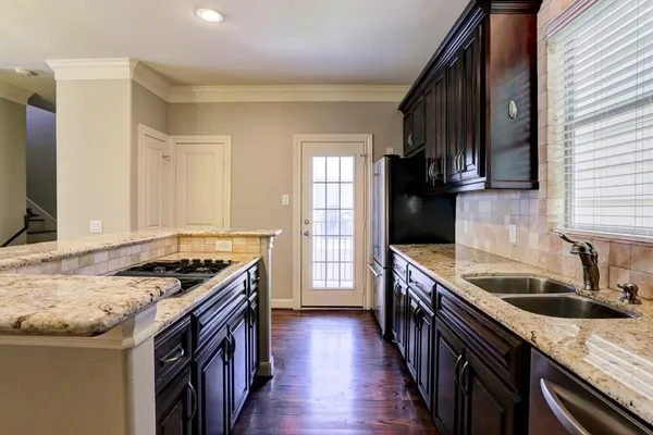 a view of a dining room with furniture a chandelier and wooden floor