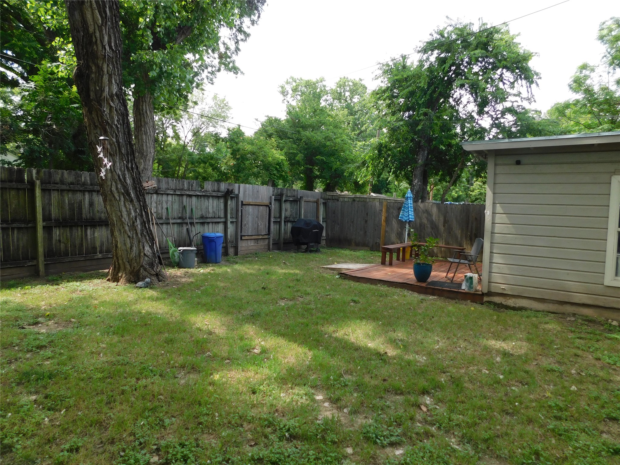 1304 South 19th Street Temple, TX 76504 - Photo 6 of 6 a view of a backyard with a small cabin and a chair