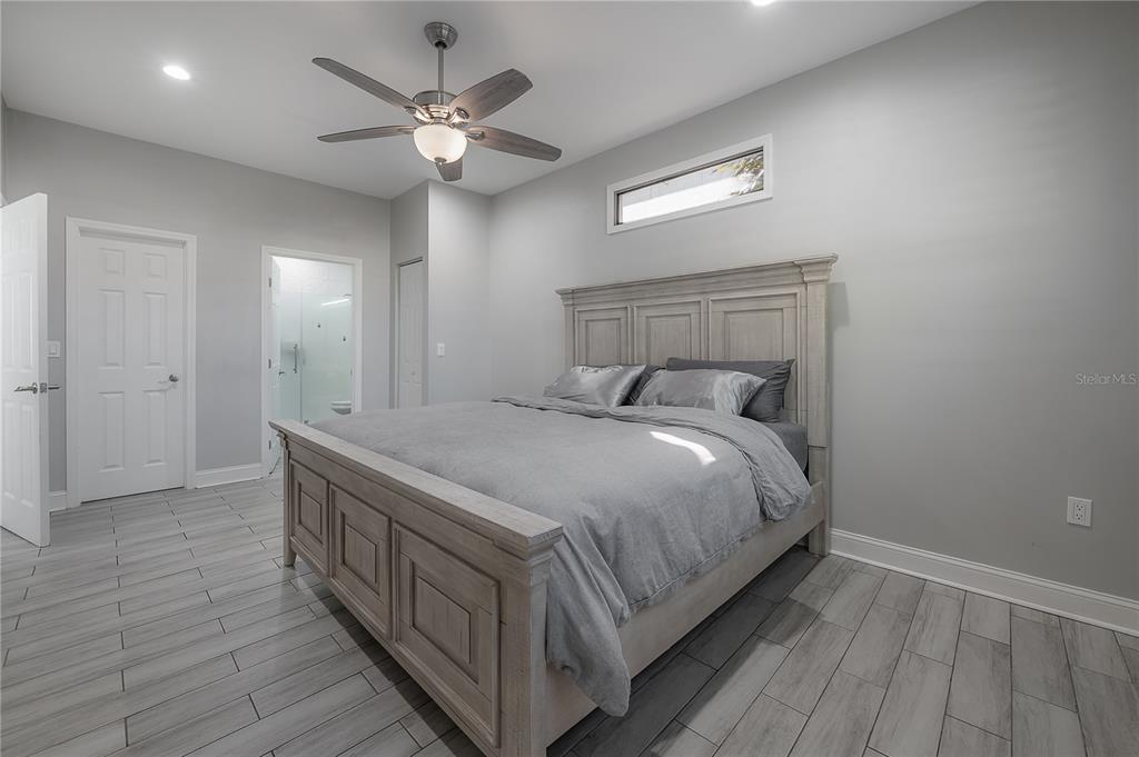 2341 West Chestnut Street Tampa, FL 33607 - Photo 17 of 42 a bed room with a bed and a ceiling fan