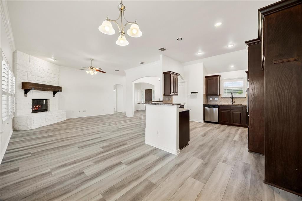 528 Hubbard Circle Nevada, TX 75173 - Photo 23 of 36 Kitchen with stainless steel appliances, dark brown cabinets, tasteful backsplash, dark stone countertops, and recessed lighting