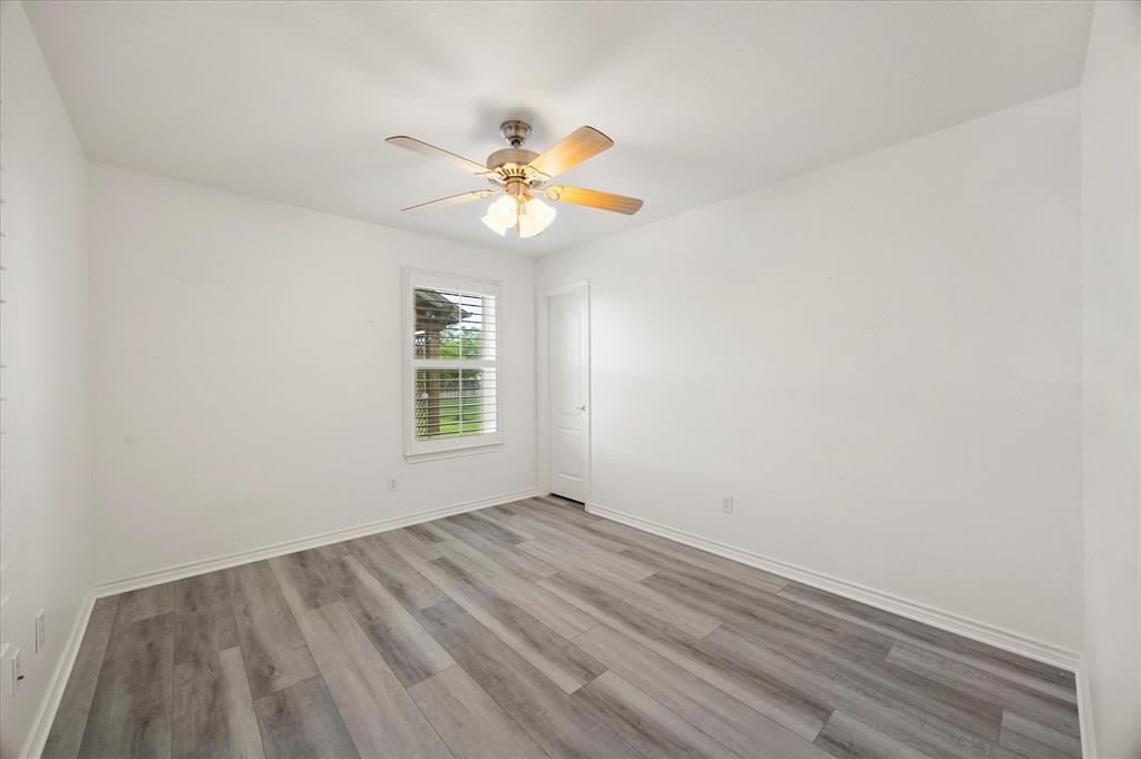 528 Hubbard Circle Nevada, TX 75173 - Photo 28 of 36 Unfurnished room featuring light wood finished floors, ceiling fan, and baseboards