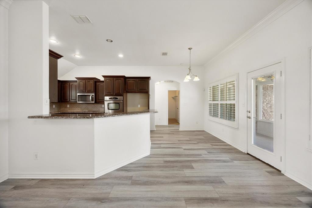 528 Hubbard Circle Nevada, TX 75173 - Photo 36 of 36 Kitchen with stainless steel appliances, dark brown cabinets, tasteful backsplash, dark stone countertops, and recessed lighting