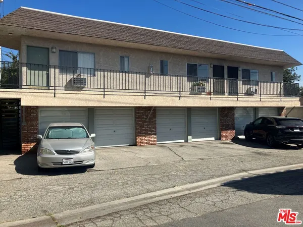 a front view of a house with car parked