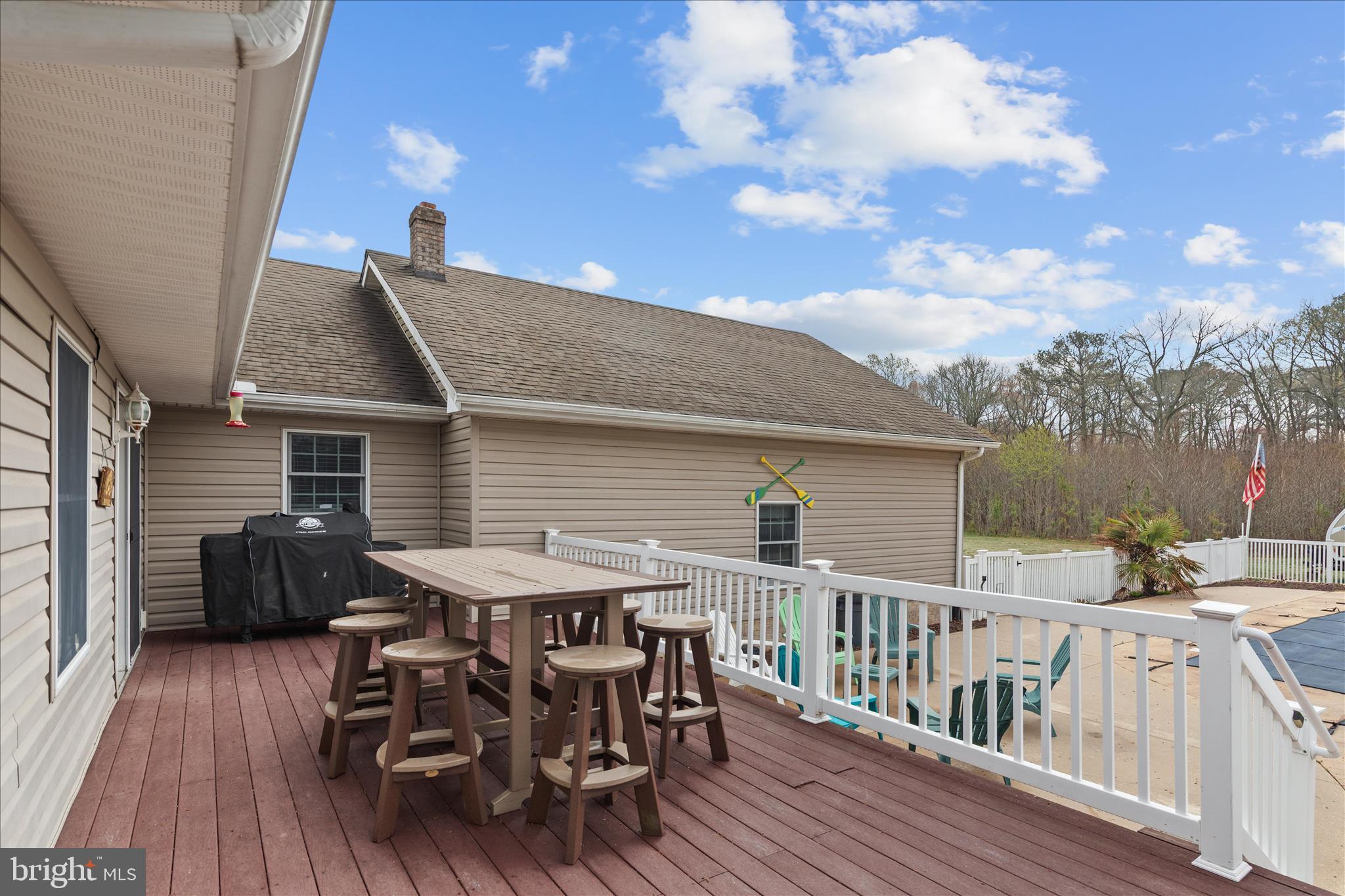 12647 Old Stage Road Bishopville, MD 21813 - Photo 80 of 84 a terrace of a house with wooden floor outdoor seating and yard in the back