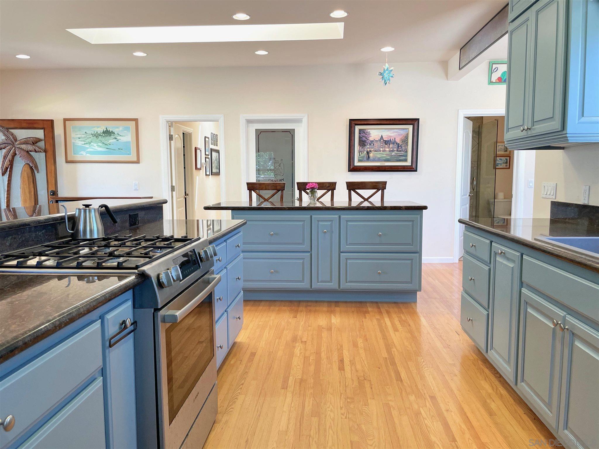 950 Cabrillo Avenue Coronado, CA 92118 - Photo 11 of 31 a kitchen with wooden floors and appliances