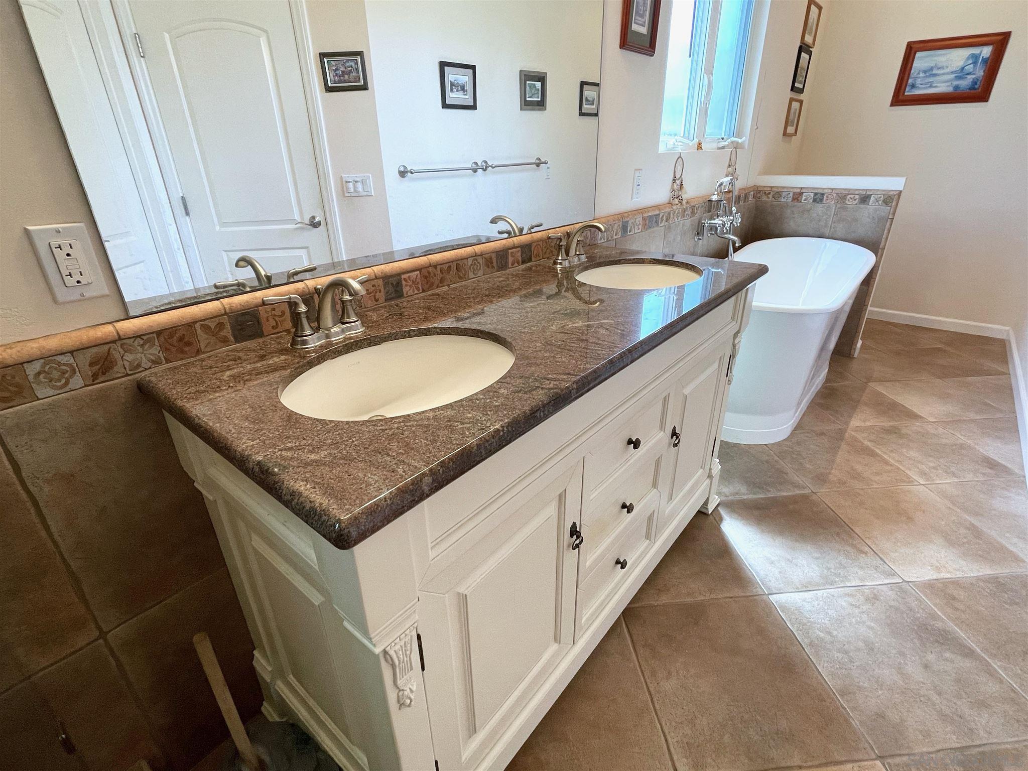 950 Cabrillo Avenue Coronado, CA 92118 - Photo 19 of 31 a bathroom with a granite countertop sink and a mirror