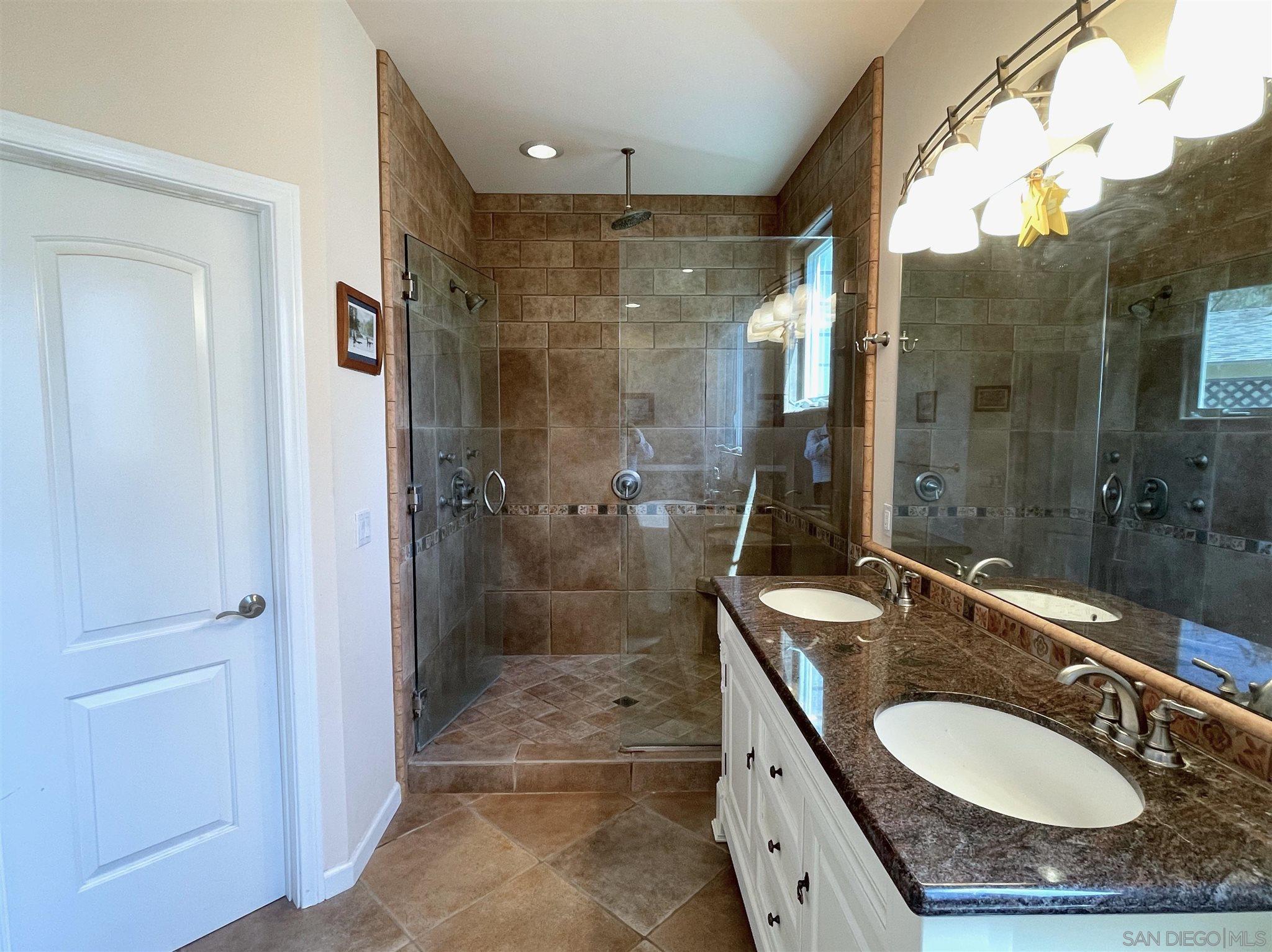 950 Cabrillo Avenue Coronado, CA 92118 - Photo 20 of 31 a bathroom with a granite countertop sink shower mirror and toilet
