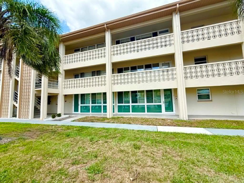 4455 Duhme Road, Unit 103 St. Petersburg, FL 33708 - Photo 3 of 37 front view of a building with a garden