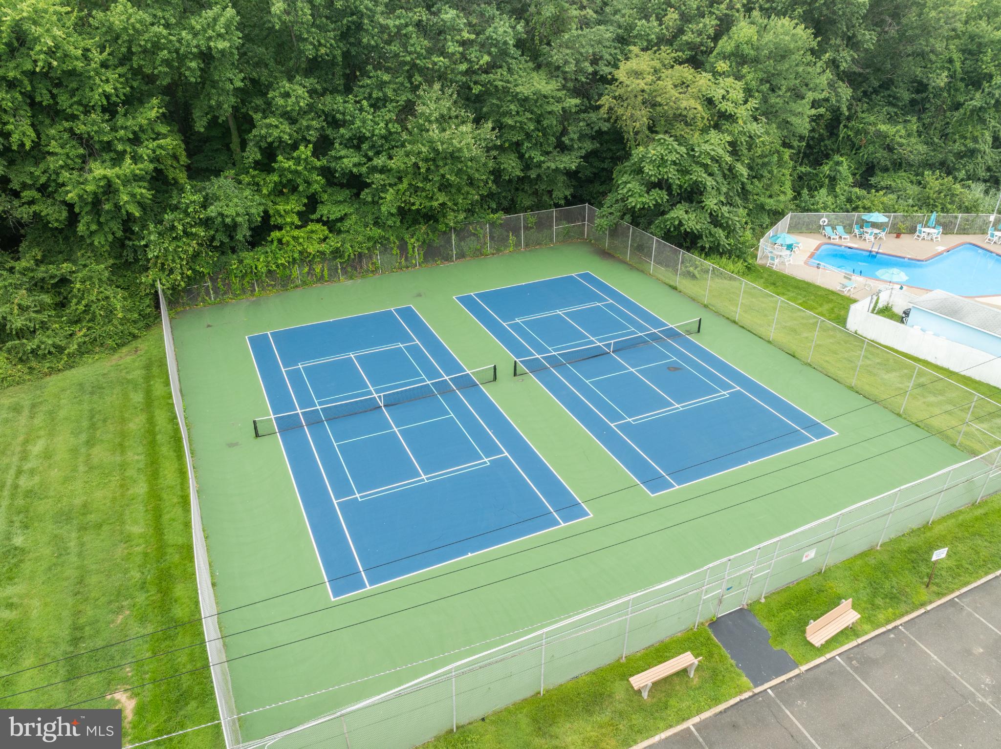 1840 Frontage Road, Unit 1704 Cherry Hill, NJ 08034 - Photo 35 of 39 Tennis courts amidst lush greenery.