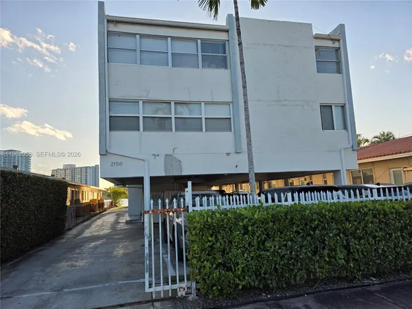 a front view of a building with a garden