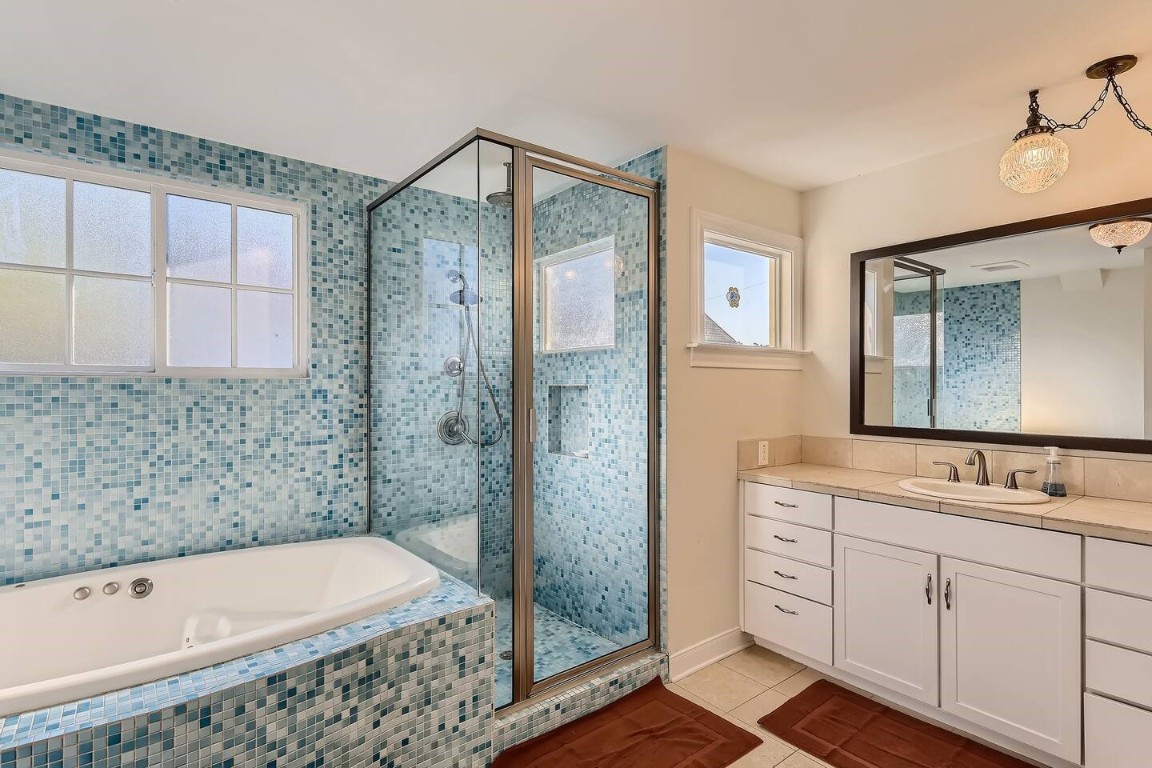 2704 Stacy Lane Austin, TX 78704 - Photo 11 of 15 Full bath featuring a shower stall, light tile patterned floors, vanity, and a garden tub
